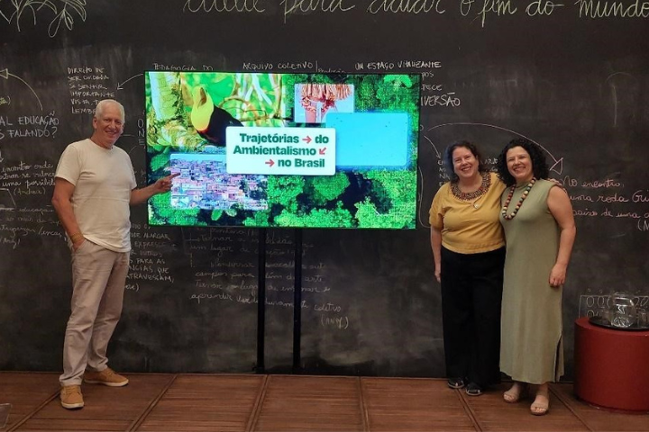 Foto mostra coordenadores(as) da Cátedra Sustentabilidade e Visões de Futuro e pró-reitora de Extensão e Cultura da Unifesp ao redor de tela onde está escrito Trajetórias do Ambientalismo no Brasil